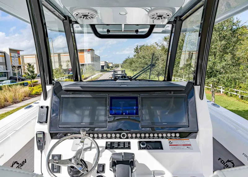 Slide: The Image of 2026 Fountain 38 TE boat dashboard with dual Garmin screens and steering wheel. - 11