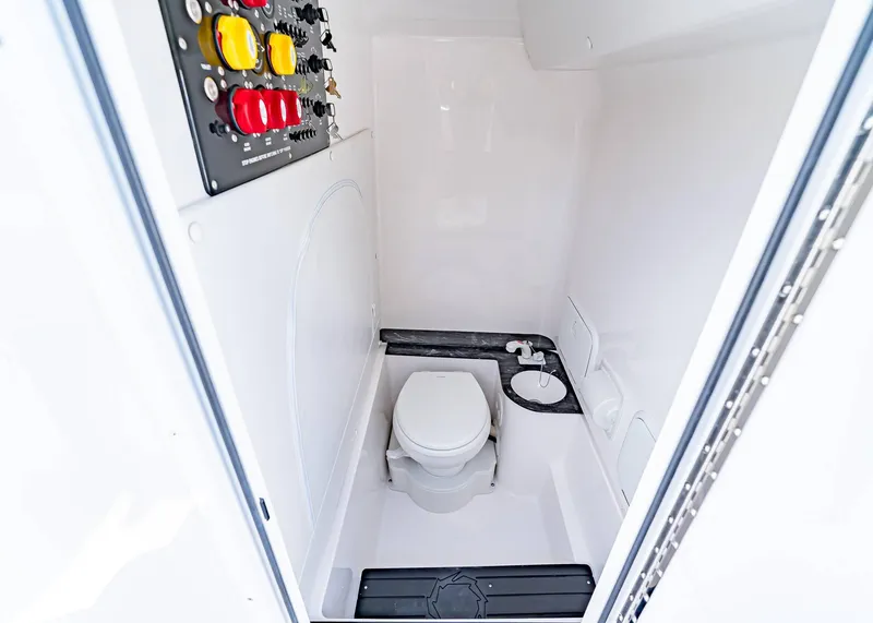 Slide: The Image of 2026 Fountain 38 TE boat interior with compact marine toilet and control panel. - 14