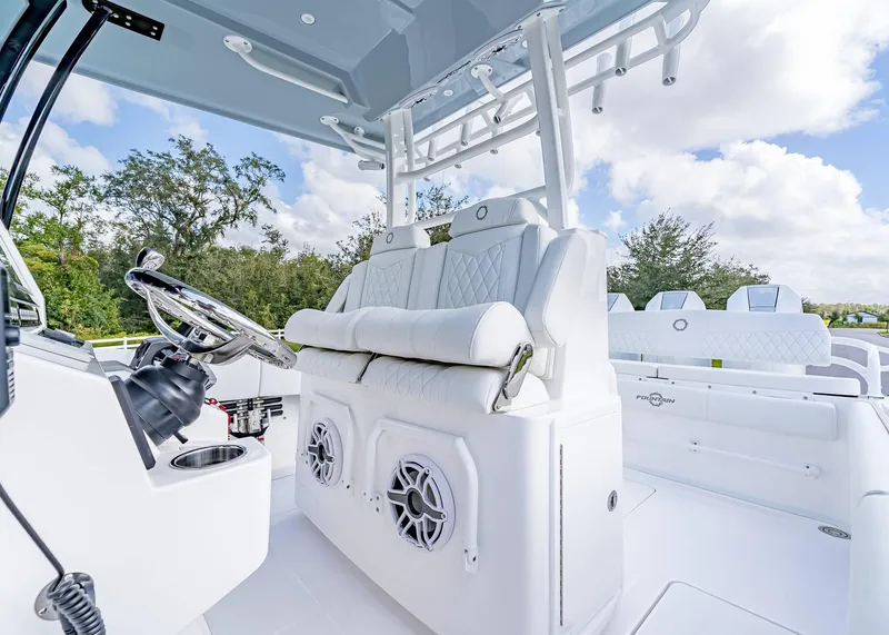 Slide: The Image of 2026 Fountain 38 TE boat interior with white seating and modern steering console. - 17