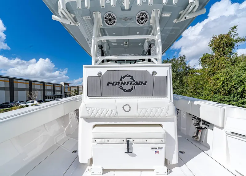 Slide: The Image of 2026 Fountain 38 TE boat interior with seating and storage, under a clear blue sky. - 19