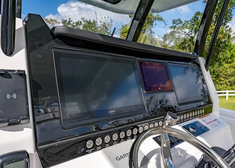 Slide: The Image of Helm of 2026 Fountain 38 TE boat with modern navigation displays and controls. - 23