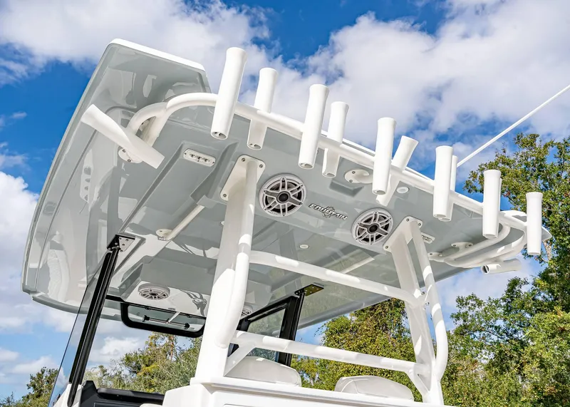 Slide: The Image of 2026 Fountain 38 TE boat with rod holders and speakers under a clear blue sky. - 26