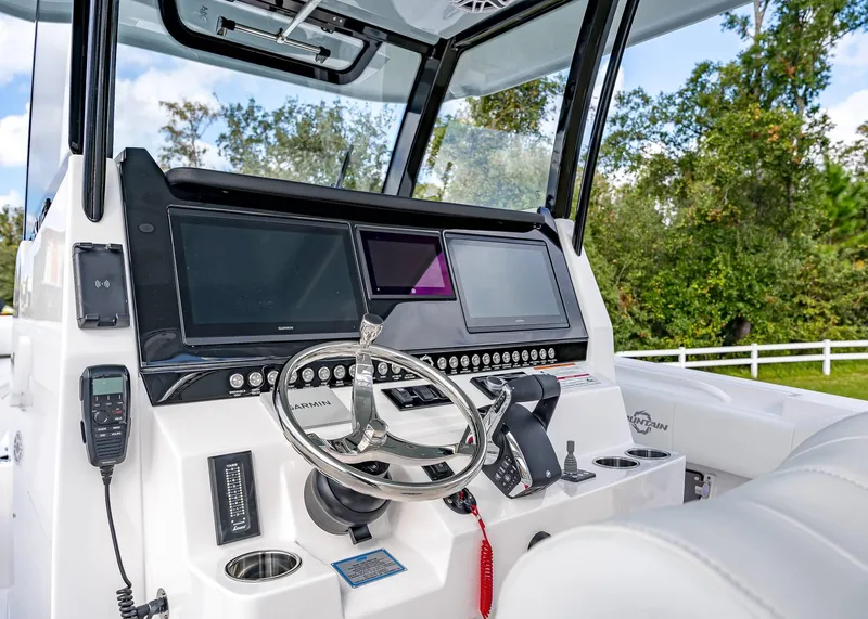 Slide: The Image of 2026 Fountain 38 TE boat dashboard with advanced navigation screens and controls. - 29