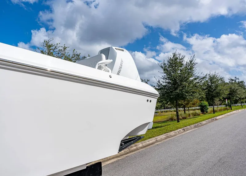 Slide: The Image of 2026 Fountain 38 TE boat on trailer, parked roadside under blue sky. - 3