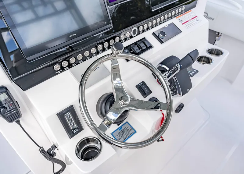 Slide: The Image of Control panel of 2026 Fountain 38 TE boat with steering wheel and navigation equipment. - 30