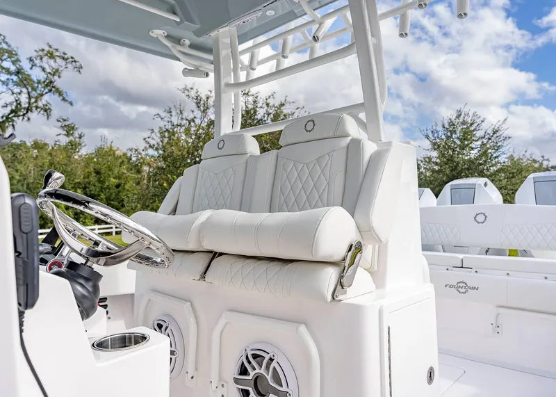 Slide: The Image of 2026 Fountain 38 TE boat interior with white seating and steering wheel. - 31
