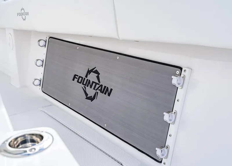 Slide: The Image of 2026 Fountain 38 TE boat interior detail with logo and rod holders. - 8
