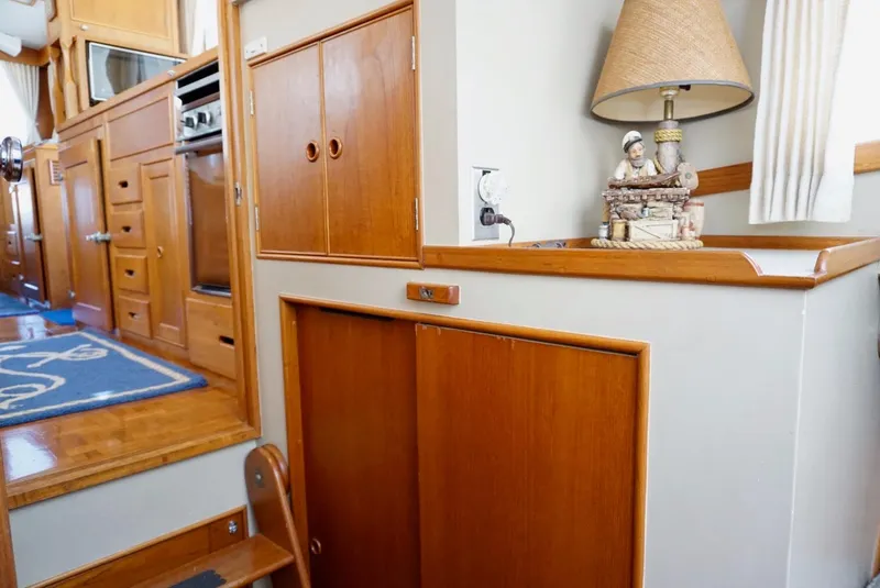 Slide: The Image of Interior of 1982 Grand Banks Classic yacht with wooden table and cushioned seating. - 11