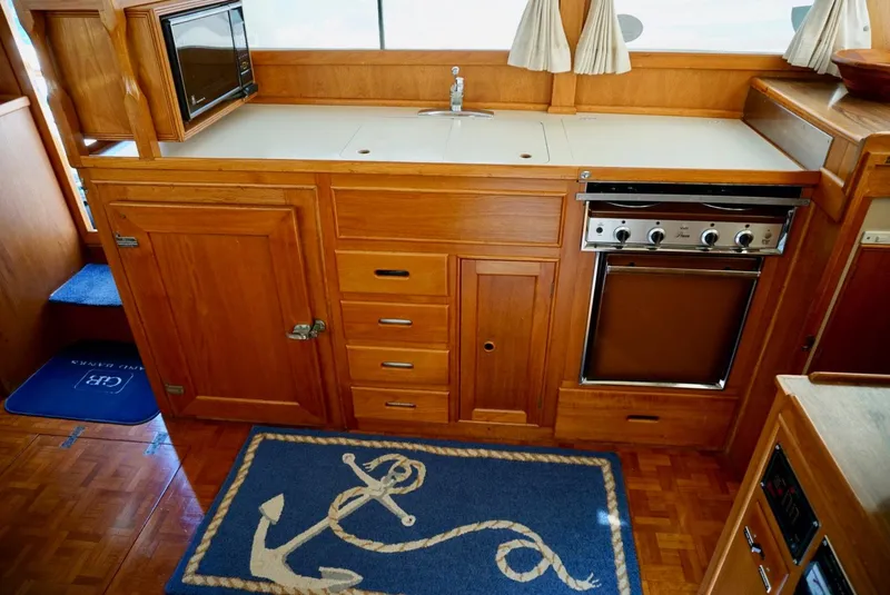 Slide: The Image of 1982 Grand Banks Classic yacht interior with wooden cabinetry and nautical decor. - 12