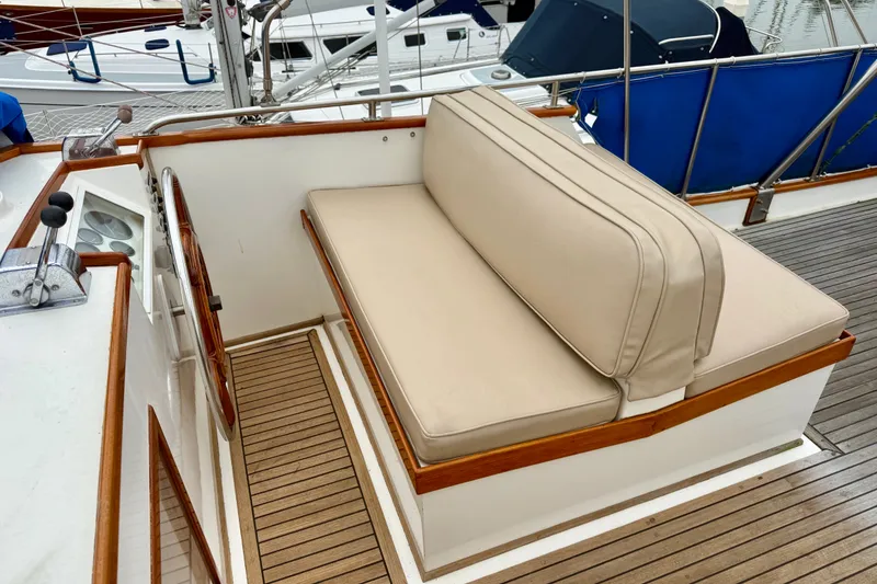 Slide: The Image of 1982 Grand Banks 42 Classic yacht with beige seating and wooden deck details. - 13