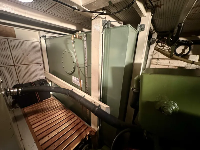 Slide: The Image of 1982 Grand Banks Classic interior with wooden cabinetry, cozy bed, and blue carpeted flooring. - 30