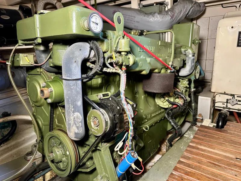 Slide: The Image of Engine room of a 1982 Grand Banks Classic boat, featuring a green marine engine. - 54