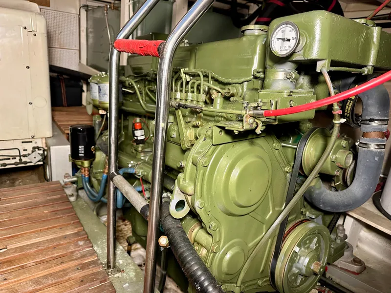 Slide: The Image of Engine room of a 1982 Grand Banks Classic boat, showcasing a green marine engine. - 55