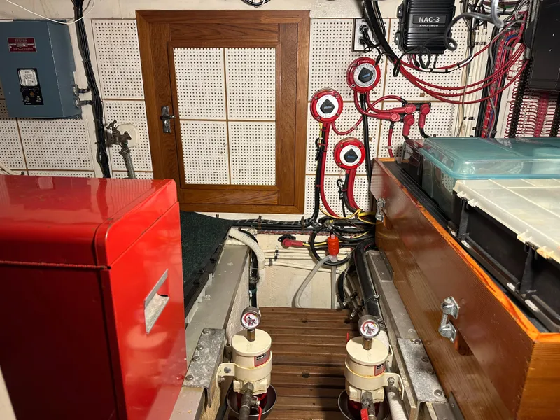 Slide: The Image of Engine room of a 1982 Grand Banks Classic boat with red and wooden components. - 60