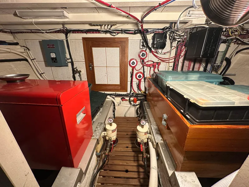 Slide: The Image of Engine room of 1982 Grand Banks Classic boat with equipment and wiring. - 61