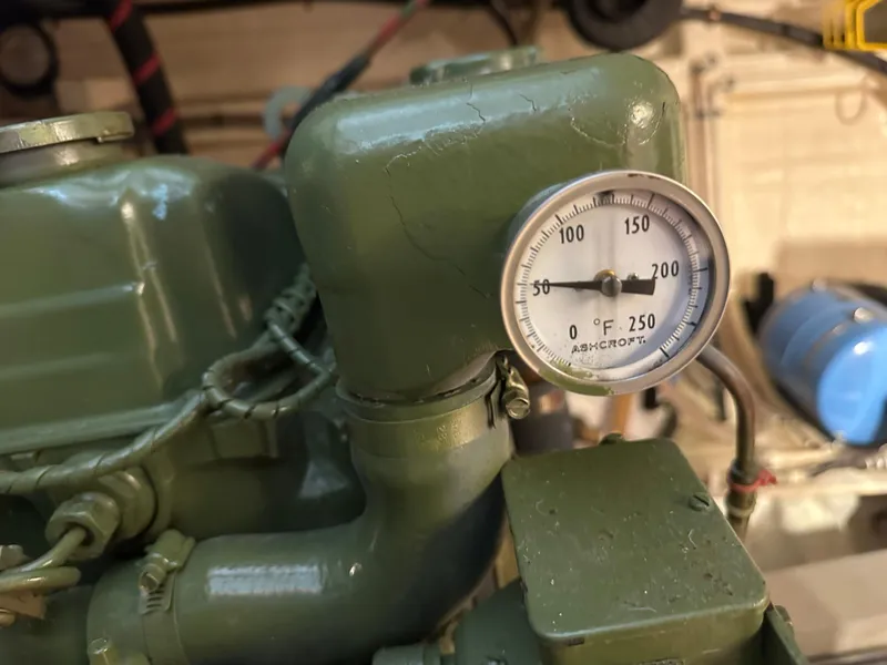 Slide: The Image of 1982 Grand Banks Classic engine with temperature gauge, showing 0 to 250°F range. - 63