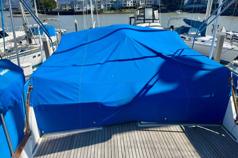 Slide: The Image of 1982 Grand Banks 42 Classic yacht with blue cover at marina. - 68