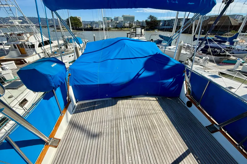 Slide: The Image of 1982 Grand Banks 42 Classic yacht deck with blue covers in marina setting. - 69