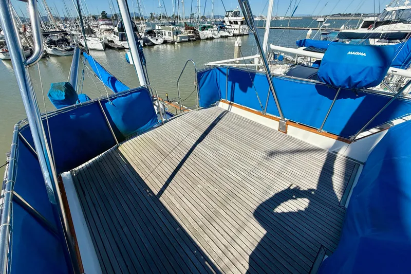Slide: The Image of 1982 Grand Banks 42 Classic yacht deck with blue covers in marina setting. - 70
