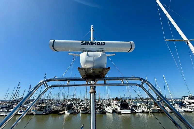 Slide: The Image of Radar equipment on 1982 Grand Banks 42 Classic yacht in marina under clear blue sky. - 72