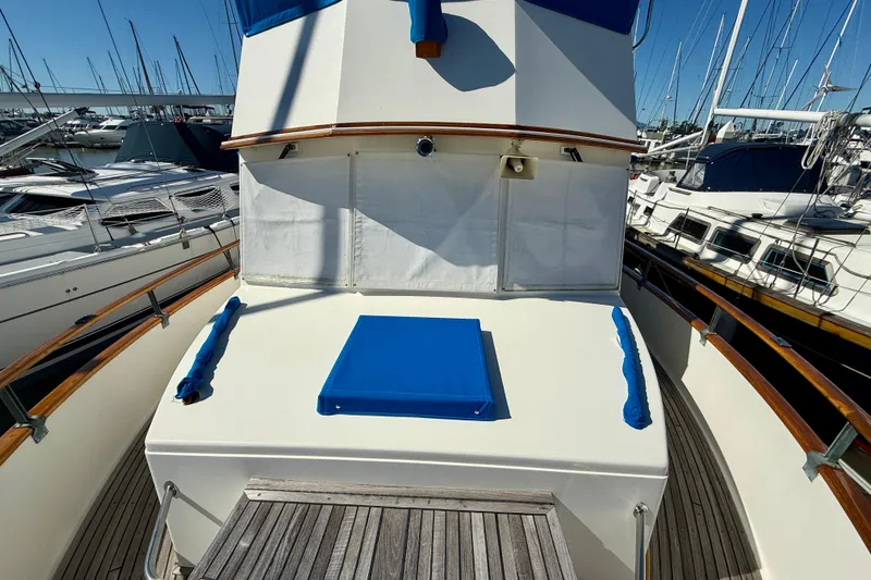 Slide: The Image of 1982 Grand Banks 42 Classic yacht deck with blue accents, docked in marina. - 74