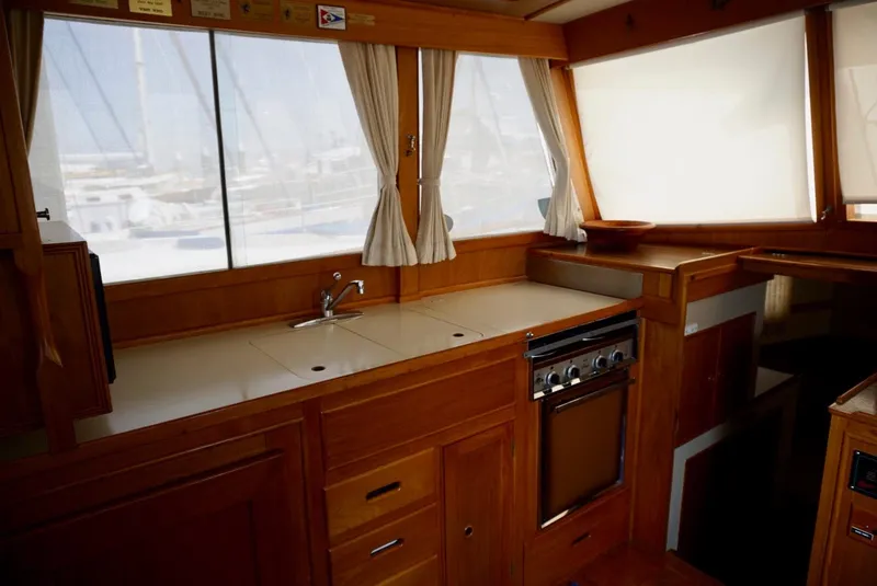 Slide: The Image of Interior of 1982 Grand Banks Classic yacht with wood finish and cozy seating area. - 9