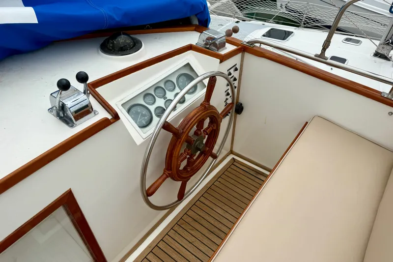 Slide: The Image of Helm of 1982 Grand Banks 42 Classic yacht with wooden wheel and instrument panel. - 14