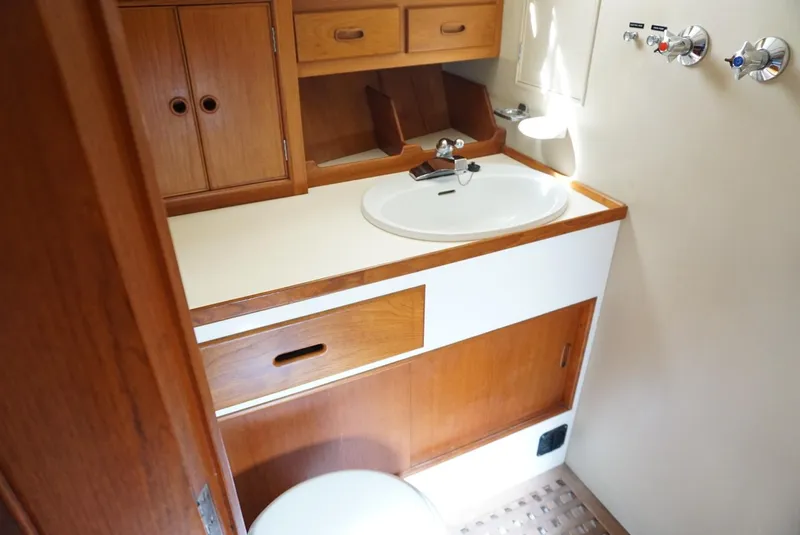Slide: The Image of 1982 Grand Banks Classic yacht bathroom with wooden cabinetry and white sink. - 10