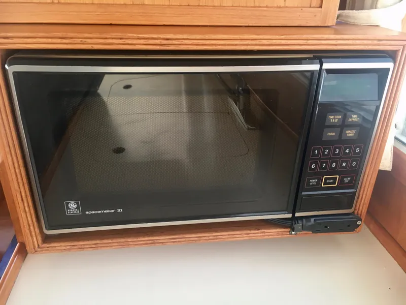 Slide: The Image of 1982 Grand Banks Classic microwave in wooden kitchen setting. - 22