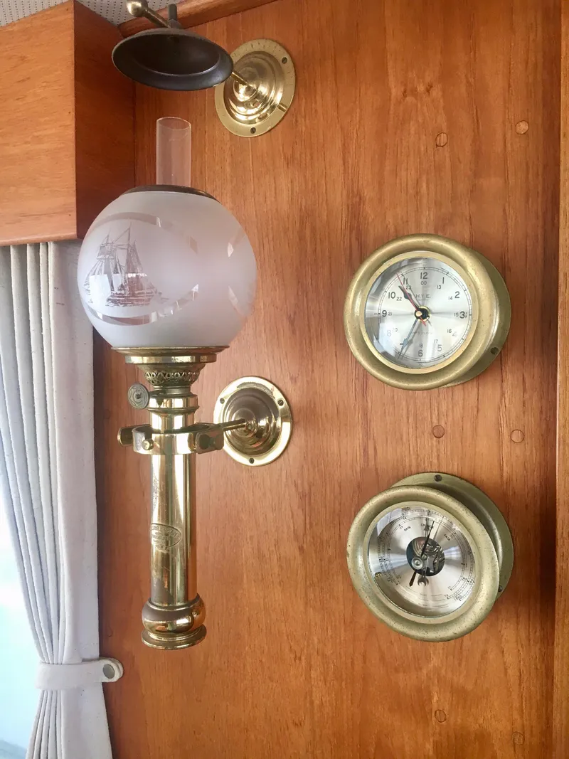 Slide: The Image of Vintage brass lamp and gauges on 1982 Grand Banks Classic yacht interior. - 23