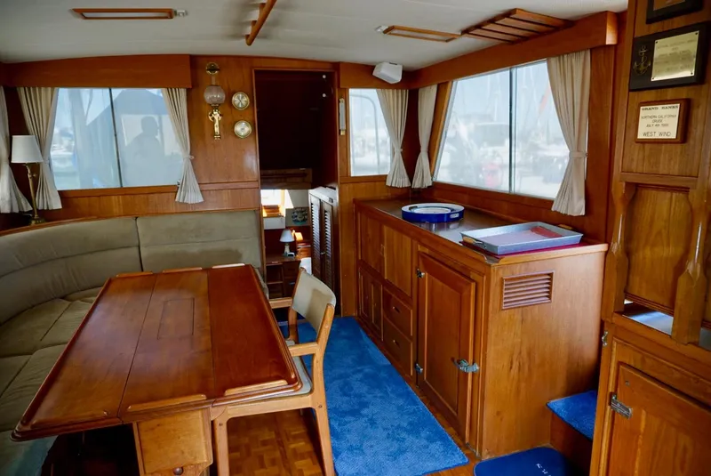 Slide: The Image of Interior of a 1982 Grand Banks Classic yacht with wooden furnishings and nautical decor. - 8