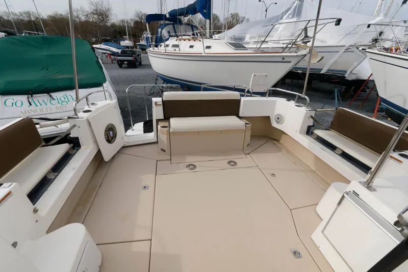 Slide: The Image of 2016 Ranger Tugs R-31S boat deck with seating, docked among other boats. - 10