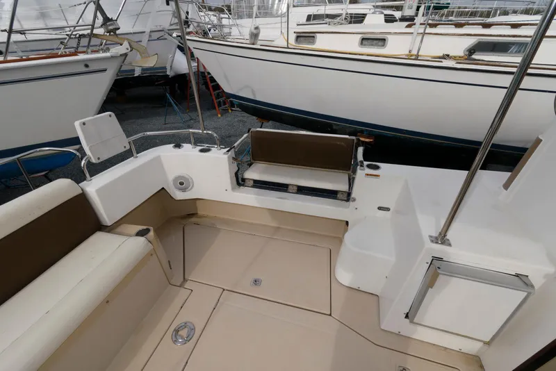 Slide: The Image of 2016 Ranger Tugs R-31S boat deck with seating, surrounded by other boats. - 11