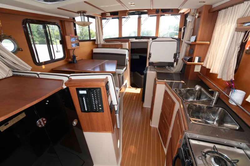 Slide: The Image of Interior of 2016 Ranger Tugs R-31S, featuring wood finishes and modern amenities. - 13