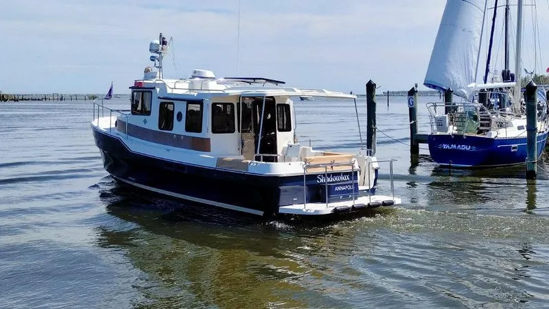 Slide: The Image of 2016 Ranger Tugs R-31S boat docked near sailboats on a sunny day. - 5