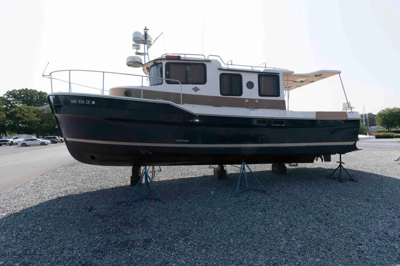 Slide: The Image of 2016 Ranger Tugs R-31S boat on stands in a gravel lot. - 8