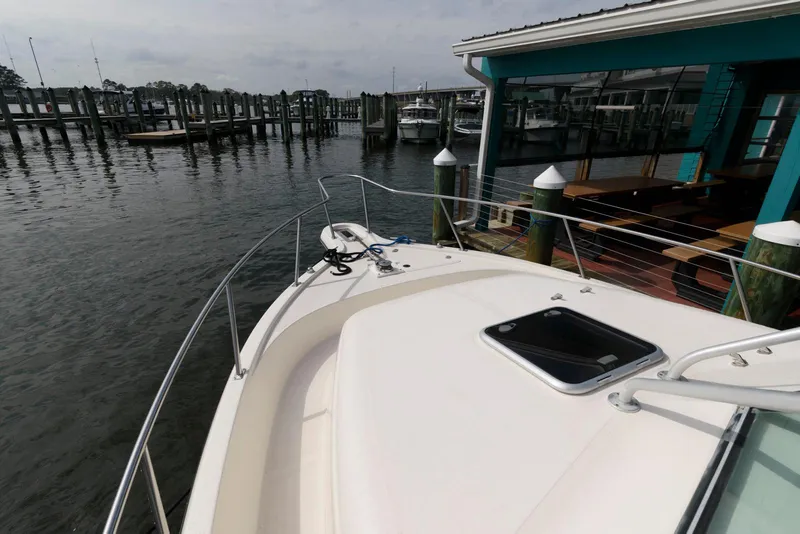 Slide: The Image of 2000 Pursuit 3070 Offshore Center Console docked at marina, view from bow. - 13