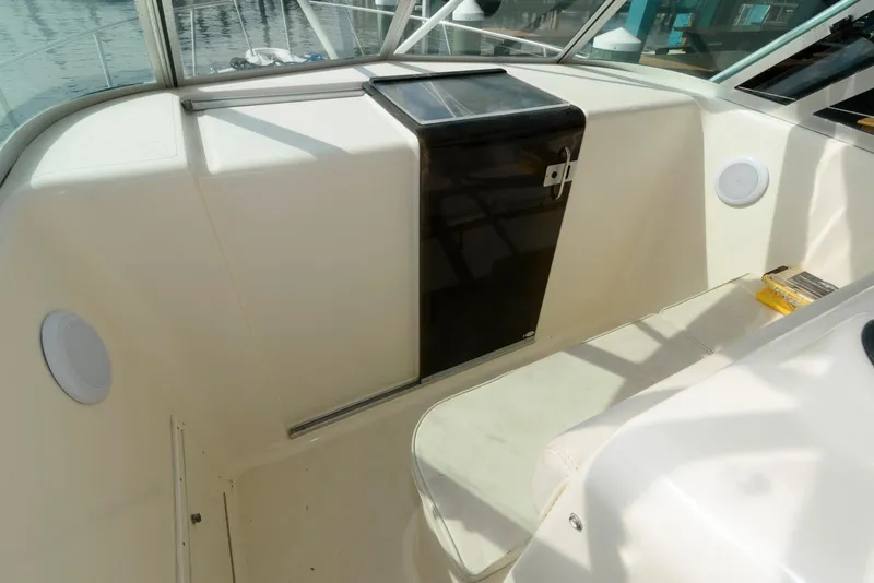 Slide: The Image of 2000 Pursuit 3070 Offshore Center Console interior with seating and storage. - 15