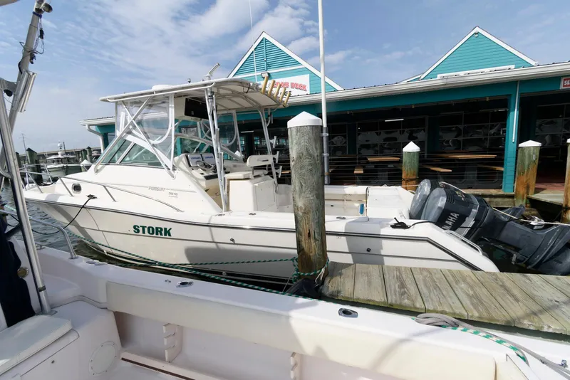 Slide: The Image of 2000 Pursuit 3070 Offshore Center Console boat docked at marina. - 4