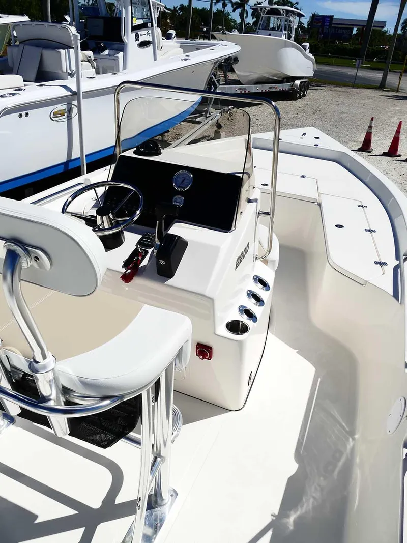 Slide: The Image of 2025 Bulls Bay 2200 boat interior with steering console and seating. - 12