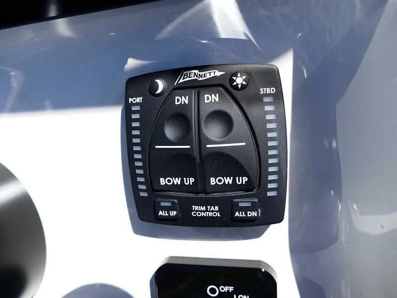 Slide: The Image of Bulls Bay 2200 2025 boat trim tab control panel with Bennett switches. - 17