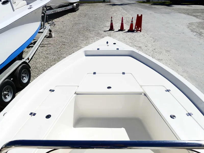 Slide: The Image of 2025 Bulls Bay 2200 boat on trailer, parked on gravel with traffic cones nearby. - 19