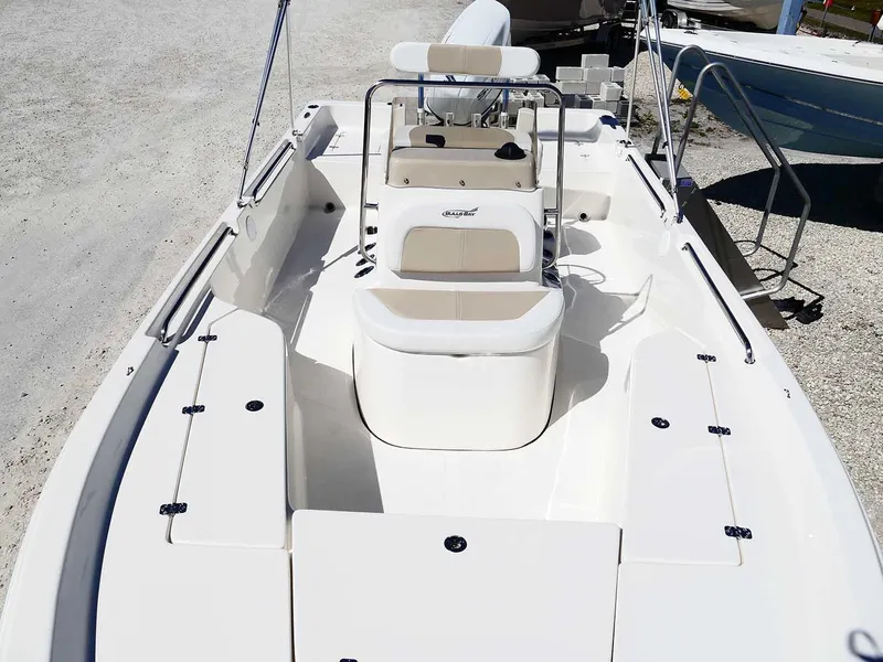 Slide: The Image of 2025 Bulls Bay 2200 boat interior with seating and console, displayed outdoors. - 24