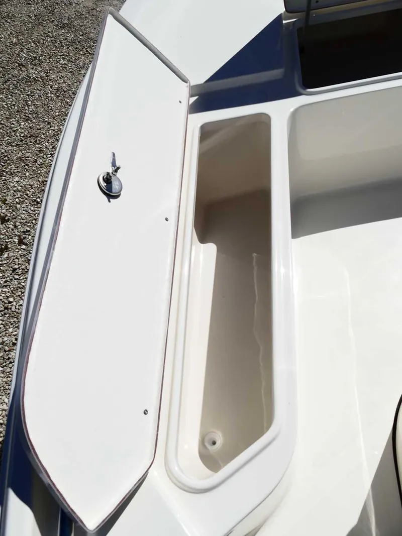 Slide: The Image of 2025 Bulls Bay 2200 boat storage compartment with open lid, showcasing interior space. - 26