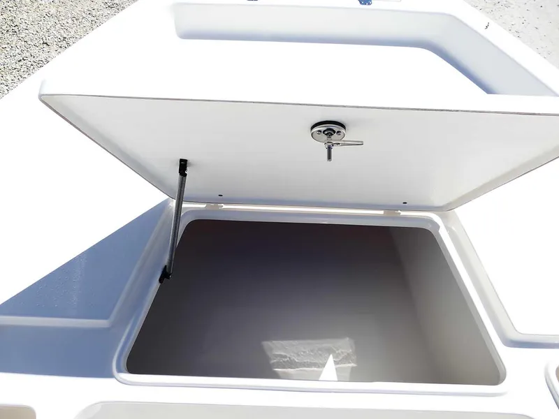 Slide: The Image of Open storage compartment on 2025 Bulls Bay 2200 boat, featuring secure latch and hydraulic support. - 27
