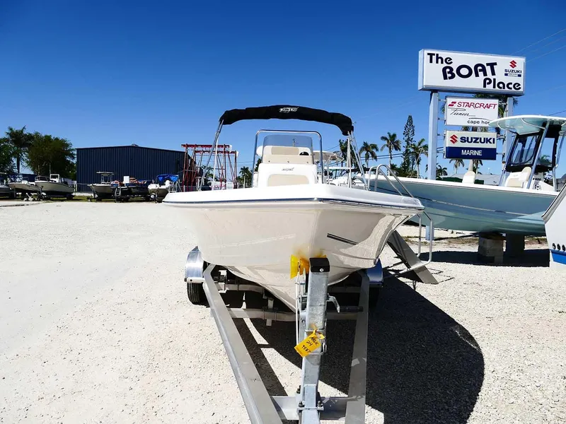Slide: The Image of 2025 Bulls Bay 2200 boat on trailer at dealership under clear blue sky. - 3