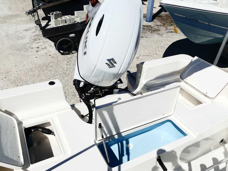 Slide: The Image of 2025 Bulls Bay 2200 boat with Suzuki outboard motor and open storage compartments. - 36
