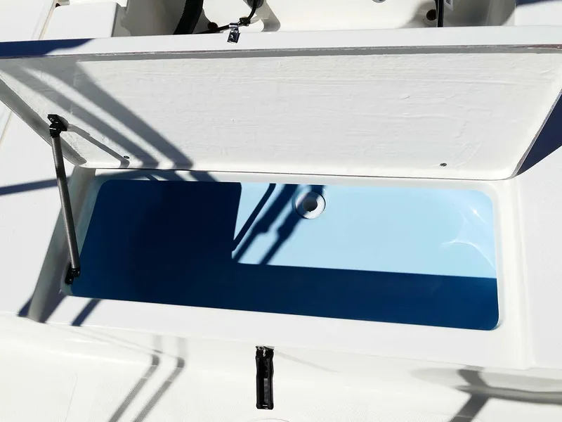 Slide: The Image of 2025 Bulls Bay 2200 boat storage compartment with open lid, showcasing interior space. - 38