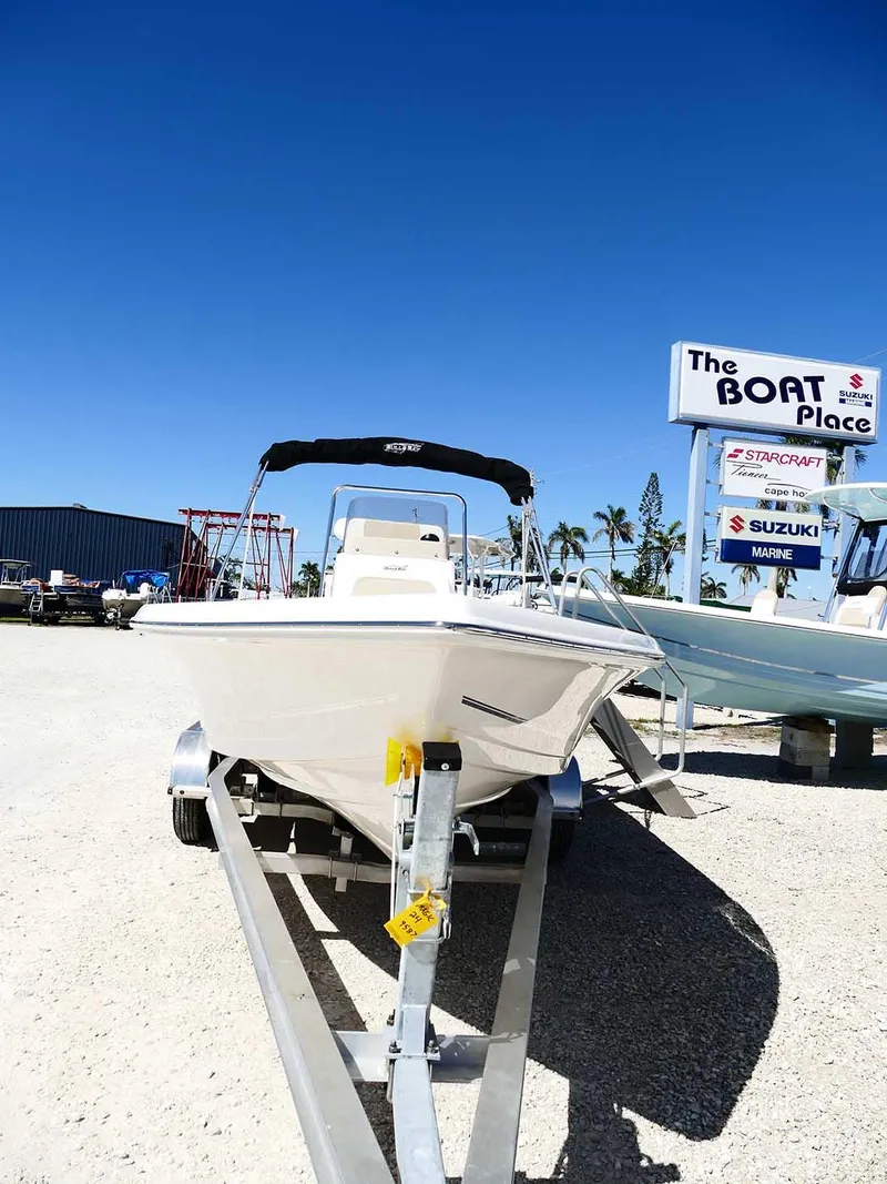 Slide: The Image of 2025 Bulls Bay 2200 boat on trailer at dealership under clear blue sky. - 4