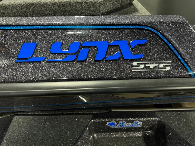 Slide: The Image of 2026 Bass Cat Lynx STS logo in blue on a metallic surface. - 12